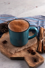 blue cup with chocolate drink and cinnamon