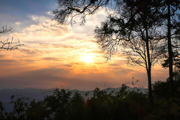 The landscape of natural mountains and hill with sunrise, trees are silhouette