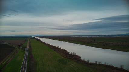 Fototapeta premium Aerial view over deep water channel heading towards Mount Diablo in the distance 