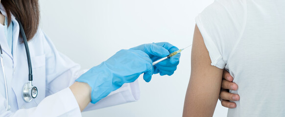 Female doctors vaccinated with syringes to prevent epidemics at hospitals, health care, and medical concepts