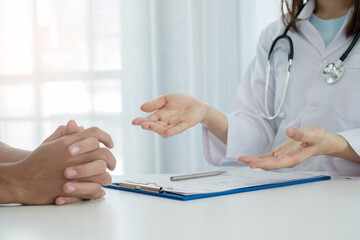 Female doctors explain and recommend treatment after a Male patient meets a doctor and receives results regarding illness problems. Medical and health care concepts
