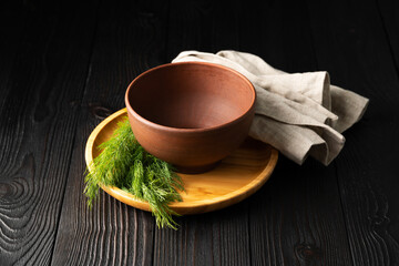 empty clay bowl on wooden background