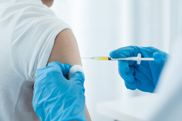Female doctors vaccinated with syringes to prevent epidemics at hospitals, health care, and medical...