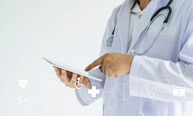 Doctor with stethoscope lies using tablet and white icon medical for working analyzing data. Examination and healthcare business technology network concept. Double exposure background. copy space