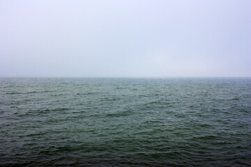 Dark green sea surface in fog