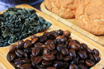 Brown coffee beans lie on the plate