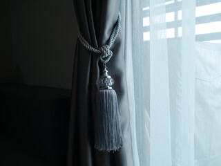 Luxury tieback for the curtain with the strong sunshine. Curtain accessories concept. 