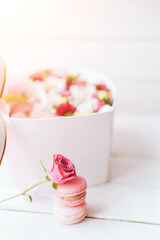 Macarons with different types of flowers in a heart-shaped box. A gift for any occasion