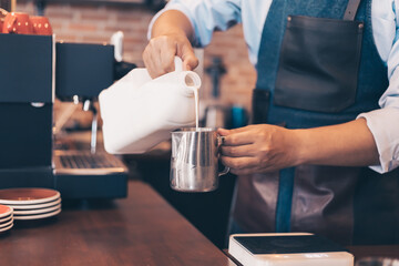 Barista making cappuccino, bartender prepare coffee drink at coffee shop .
