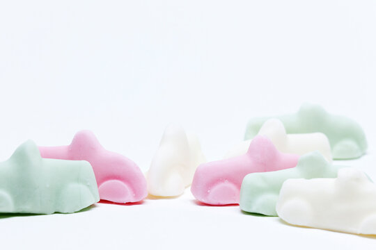 many candy cars in three different flavors on white background