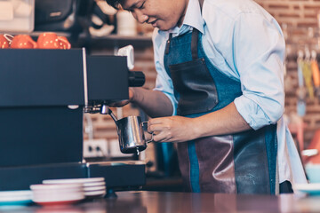 Barista making cappuccino, bartender prepare coffee drink at coffee shop .