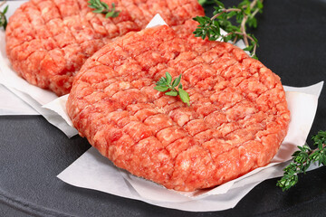 Raw minced beef patties for burgers. Raw meat for hamburgers. Beef cutlets.