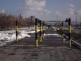 Pillars of a yellow-black ramp on a pedestrian path in the city of Novi Sad, Serbia 