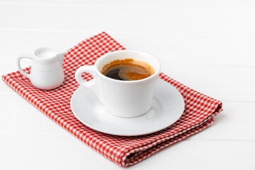 Cup of espresso coffee on saucer close up