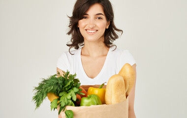cheerful woman with a package of healthy food fresh products