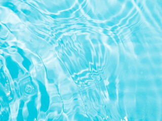 Blurred ripple water texture on blue pool background. Shadow of water on sunlight. Mockup for...