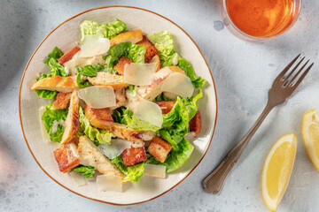 Caesar salad, top flat lay shot with wine and lemons