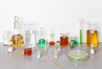 Laboratory glassware with chemicals and colored solutions on the work table. Chemical and biochemical research. Pharmacologica and technologicall analysis. Scientific background, study concept