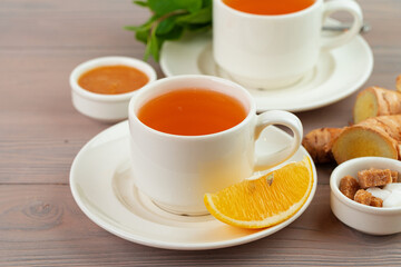 Cup of tea served with lemon and mint