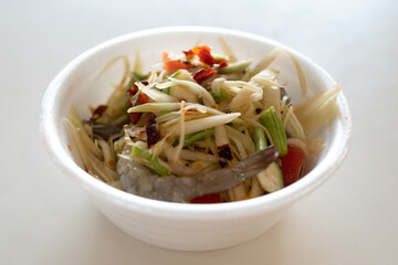 thai food - somtum in plastic bowl