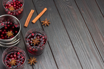 Glasses of drink with cranberries and spices