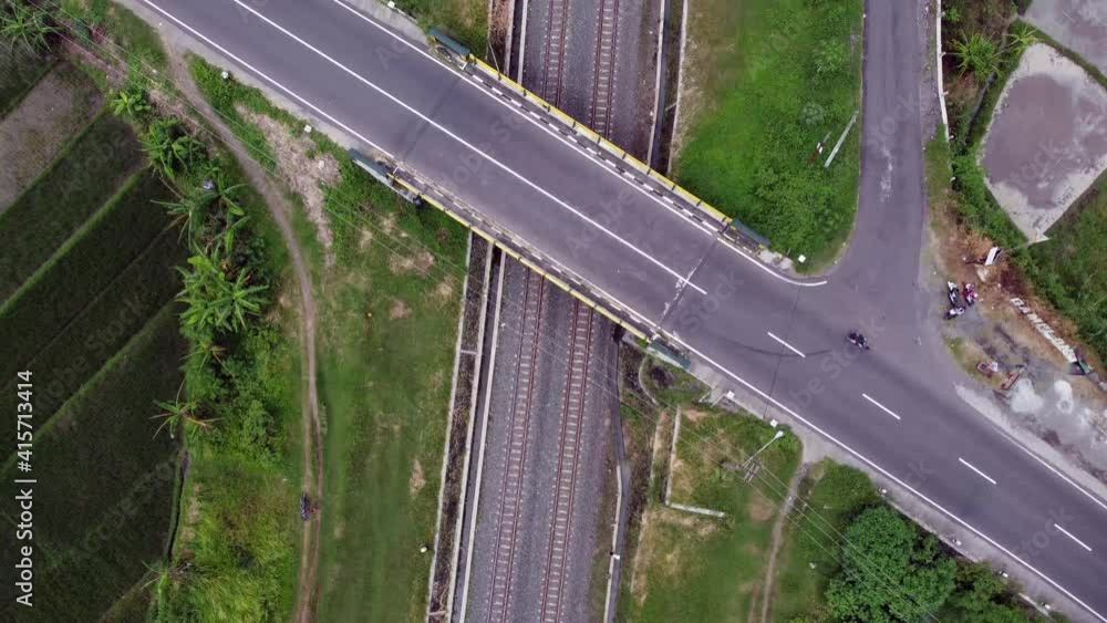 Poster aerial view of the railway line in the rice fields and under the highway
