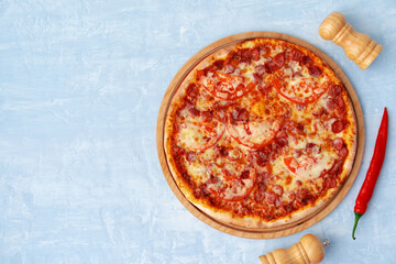 Delicious pizza with sausages on gray background
