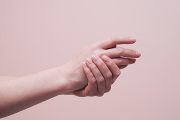 Beautiful female hands on pink background. Closeup, copy space. Cosmetology and skin care concept