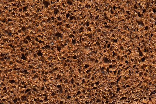 Inside part of sliced rye bread background or texture.