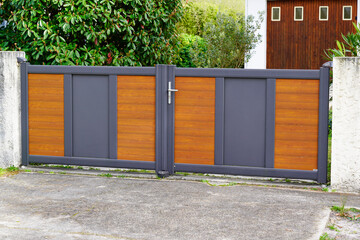 door aluminum grey and wooden brown gate portal of suburb house