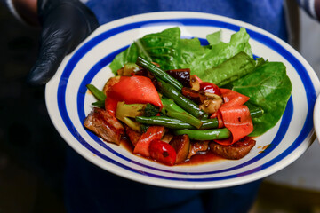 Grilled vegetables with rosemary and thyme on the white ceramic plate. Eating out concept.