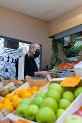 Fruit seller serving her customers