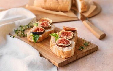 Tasty sandwiches with fig on color background