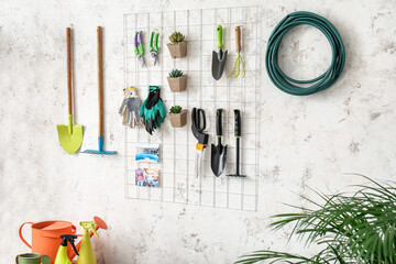 Set of gardening supplies and houseplants in barn