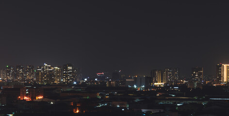 Fototapeta premium Aerial panoramic cityscape view of Ho Chi Minh city and the River Saigon, Vietnam with beautiful lights at night. Financial and business centers in developed Vietnam