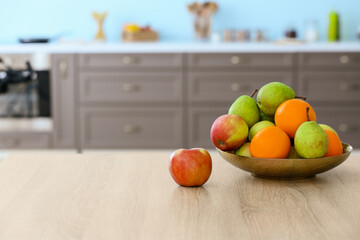 Plate with fruits on table in modern kitchen
