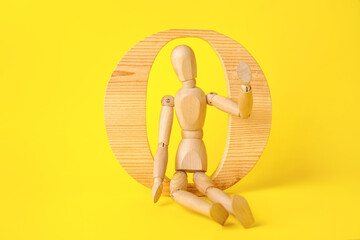 Wooden mannequin with number 0 on color background