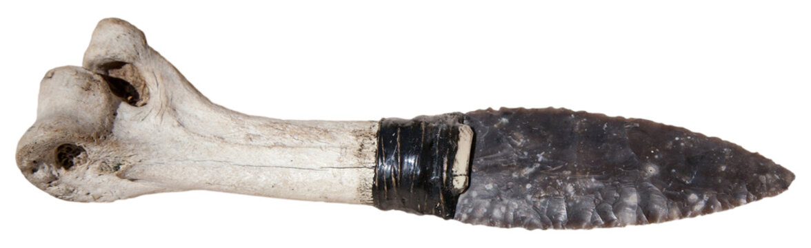 Ancient stone dagger. Historical knife with bone handle