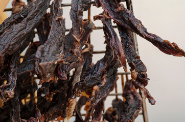 Hanging beef jerky close-up.