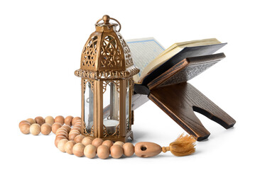 Muslim lamp, tasbih and Koran on white background