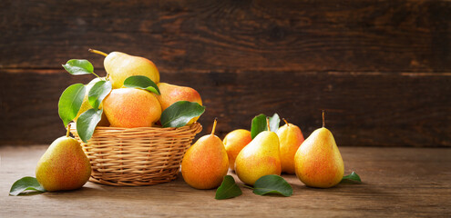 fresh ripe pears with leaves in a basket