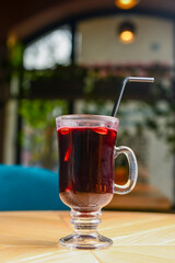 Closeup of mulled wine, one glass of steamy hot red mulled wine. Blurred background, Christmas time.