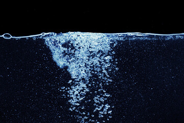 Water splash in aquarium isolated on black background