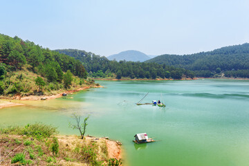Fototapeta na wymiar Amazing lake with azure water among green woods