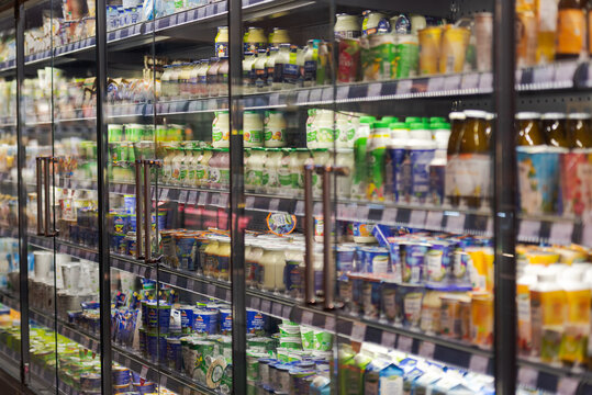 Regensburg, Germany - 2021 02 05: Refrigerated section with glass doors with various dairy products on display in organic super market