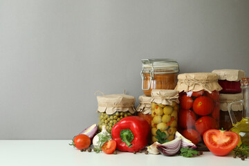 Different pickled food and ingredients against gray background