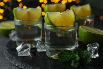 Concept of party drink with shots of vodka and blurred lights