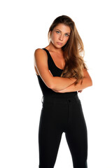 Fototapeta premium a young beautiful serious woman in pants and a shirt with crossed hands