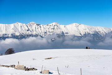 Fototapeta na wymiar Mountain range of the Monte Baldo in winter with snow, view from the Altopiano della Lessinia (Lessinia Plateau), Verona Province. Veneto and Trentino Alto Adige, Italy, Europe.