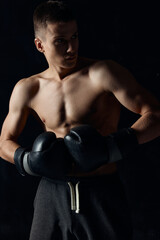 Fototapeta na wymiar male athlete boxing gloves on black background workout 
